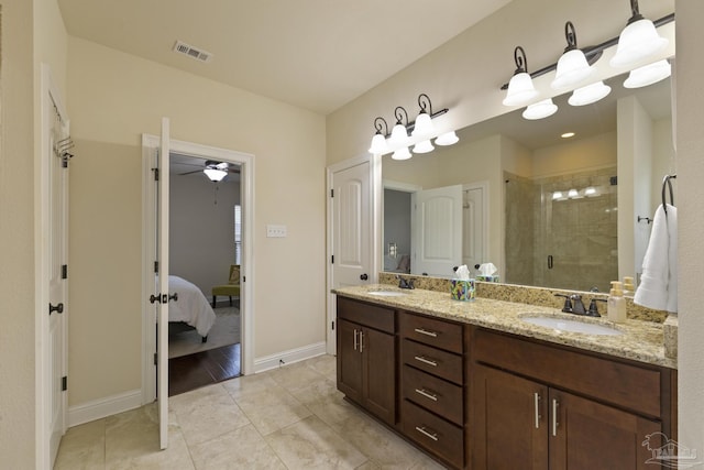 bathroom featuring ceiling fan, vanity, tile patterned flooring, and a shower with door