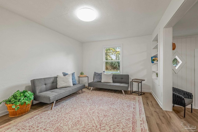 interior space with baseboards and wood finished floors
