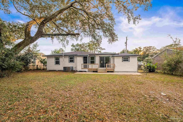 back of house with fence, a lawn, and cooling unit