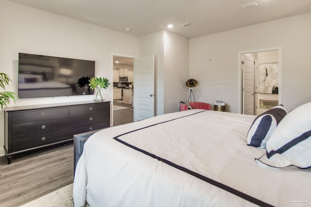 7926 Burnside Loop, Pensacola, FL 32526 - bedroom with wood finished floors, ensuite bathroom, and recessed lighting