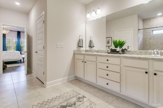 7926 Burnside Loop, Pensacola, FL 32526 - ensuite bathroom featuring double vanity, plenty of natural light, tiled shower, baseboards, and recessed lighting
