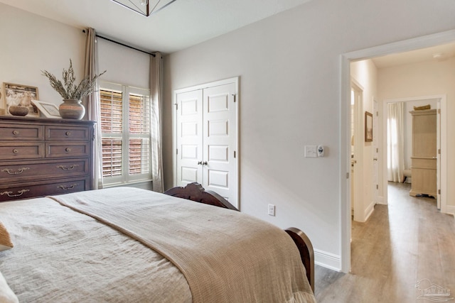 7926 Burnside Loop, Pensacola, FL 32526 - bedroom featuring light wood-style floors, a closet, and baseboards