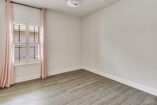 7926 Burnside Loop, Pensacola, FL 32526 - spare room featuring wood finished floors and baseboards