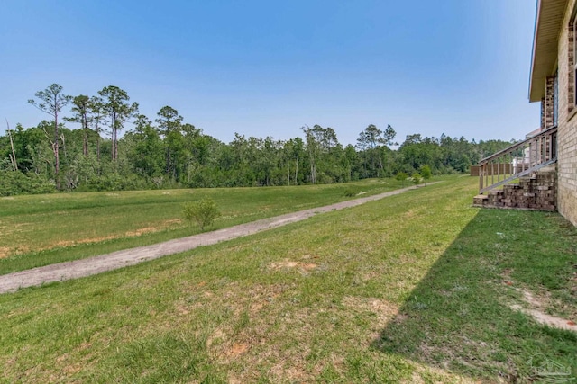 7926 Burnside Loop, Pensacola, FL 32526 - view of grassy yard with a forest view and stairs
