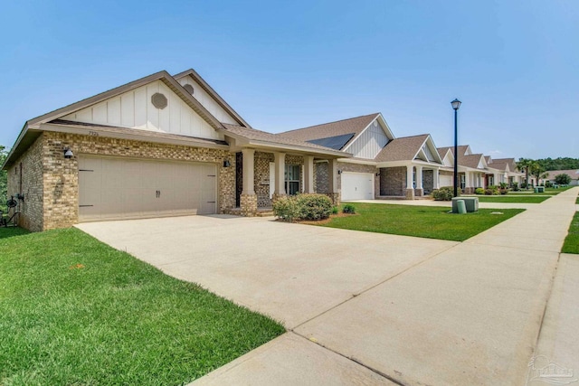 7926 Burnside Loop, Pensacola, FL 32526 - view of front of home with board and batten siding, an attached garage, brick siding, and a front lawn
