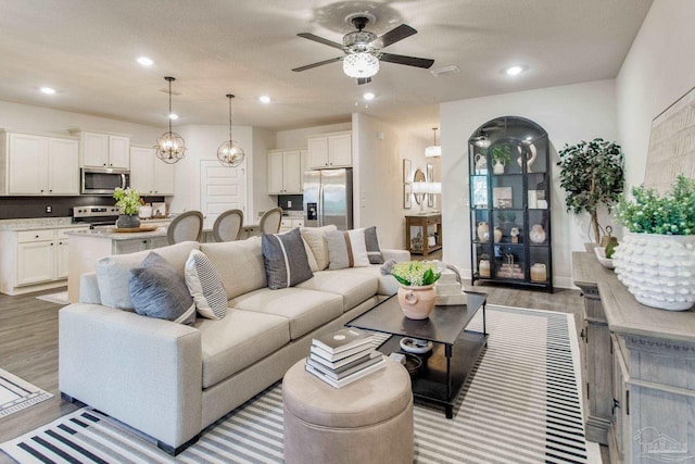 7926 Burnside Loop, Pensacola, FL 32526 - living area featuring light wood finished floors, ceiling fan, and recessed lighting
