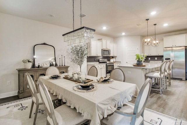 7926 Burnside Loop, Pensacola, FL 32526 - dining space with a chandelier, light wood-style floors, recessed lighting, and baseboards