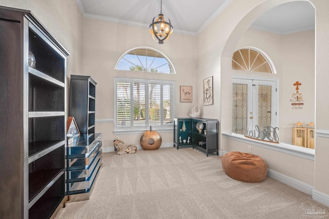 interior space with baseboards, arched walkways, crown molding, carpet floors, and a chandelier