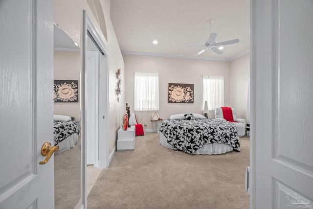 carpeted bedroom with recessed lighting, a ceiling fan, baseboards, a closet, and crown molding