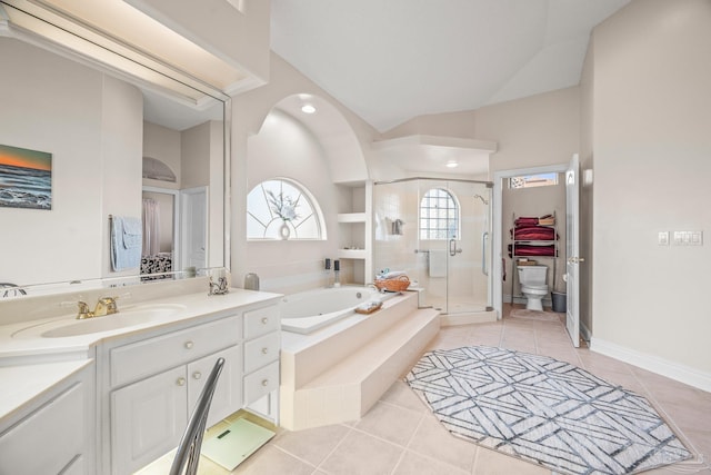 full bath featuring a garden tub, toilet, vanity, tile patterned floors, and a stall shower