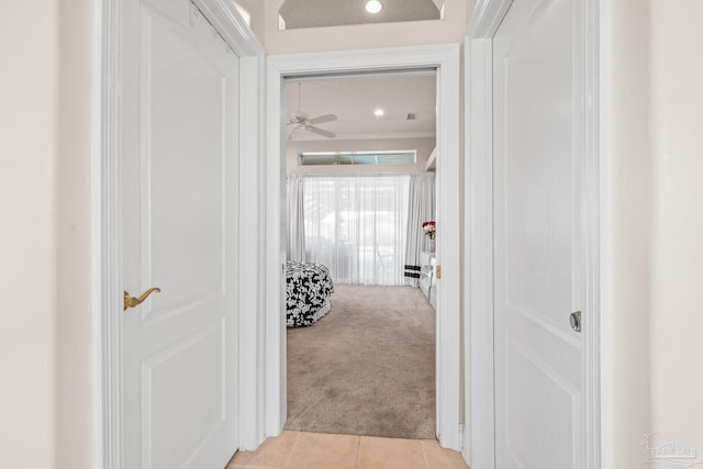 corridor featuring light carpet and light tile patterned floors