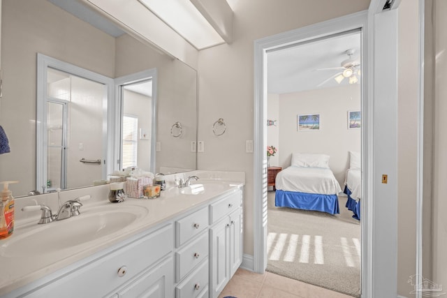 full bath with ensuite bathroom, double vanity, a sink, and tile patterned floors