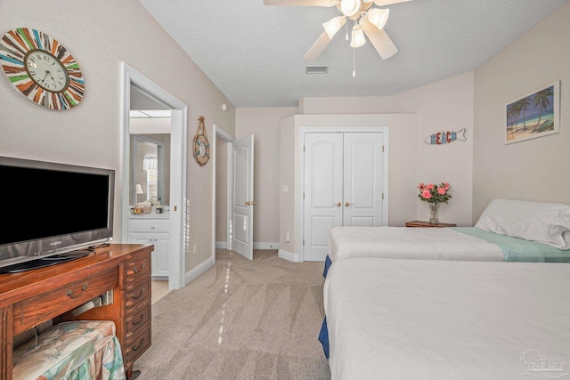 bedroom with a closet, visible vents, light carpet, ceiling fan, and baseboards