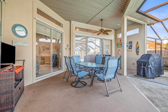 view of patio featuring outdoor dining area, a grill, a ceiling fan, and a lanai