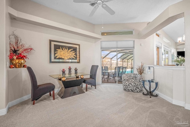 carpeted home office with visible vents, ceiling fan, a sunroom, and baseboards