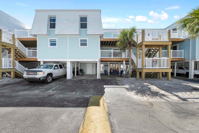 view of front of house with a carport and stairway