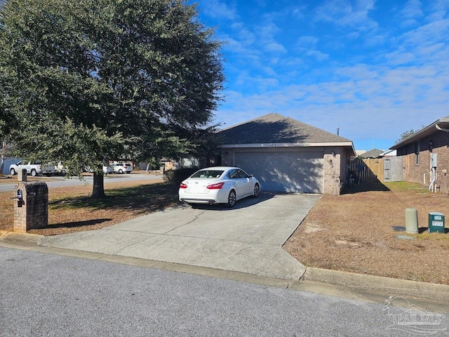 single story home with a garage, driveway, and fence