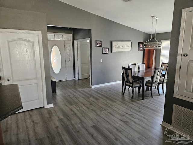 dining area with lofted ceiling, visible vents, dark wood finished floors, and baseboards