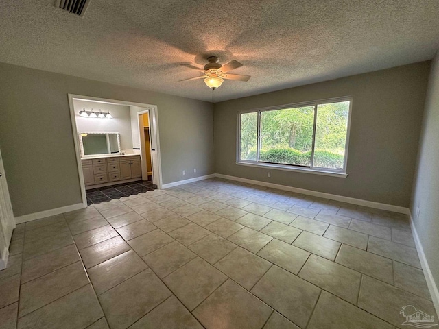 unfurnished room with ceiling fan and light tile patterned floors