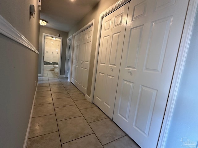 hall featuring light tile patterned flooring