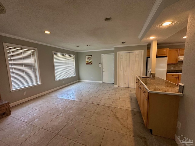 kitchen with light tile patterned flooring, sink, crown molding, a textured ceiling, and white fridge