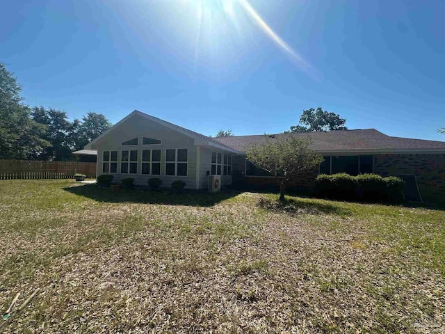 back of house with a lawn