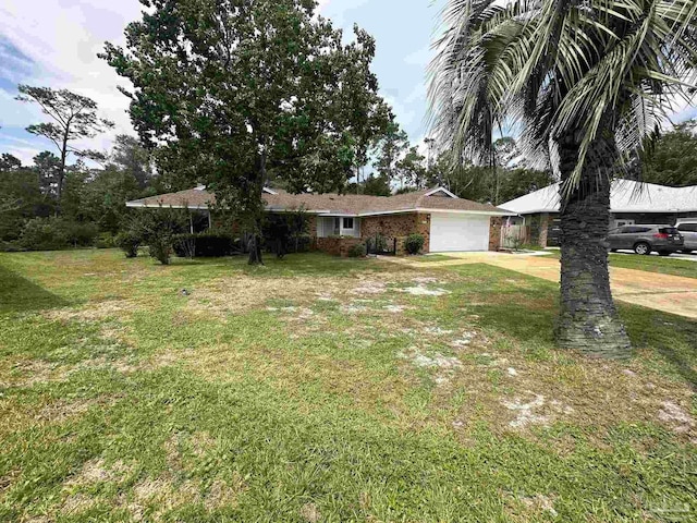 ranch-style house featuring a garage and a front lawn