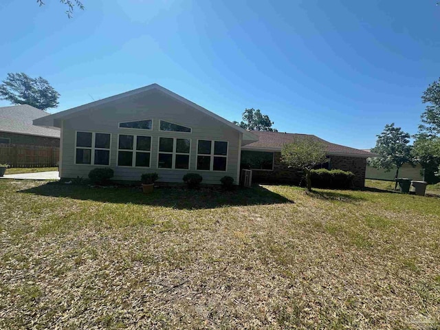 rear view of property with a yard