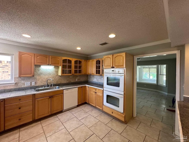 kitchen with sink, white appliances, backsplash, a textured ceiling, and light tile patterned flooring