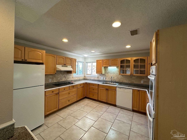 kitchen featuring sink, white appliances, ornamental molding, and light tile patterned floors