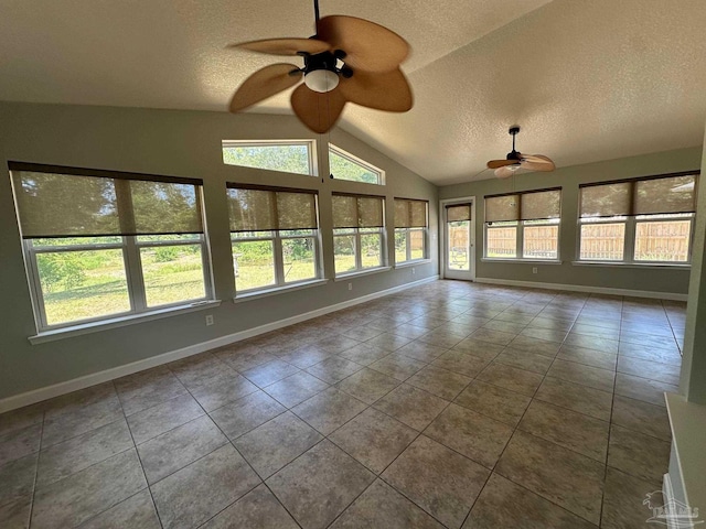 unfurnished sunroom featuring lofted ceiling, ceiling fan, and a healthy amount of sunlight