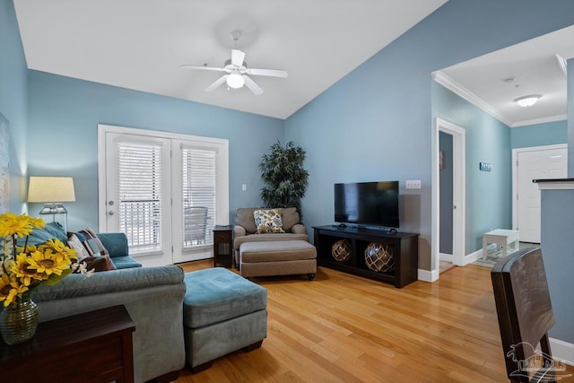 living room with baseboards, a ceiling fan, ornamental molding, vaulted ceiling, and light wood-type flooring