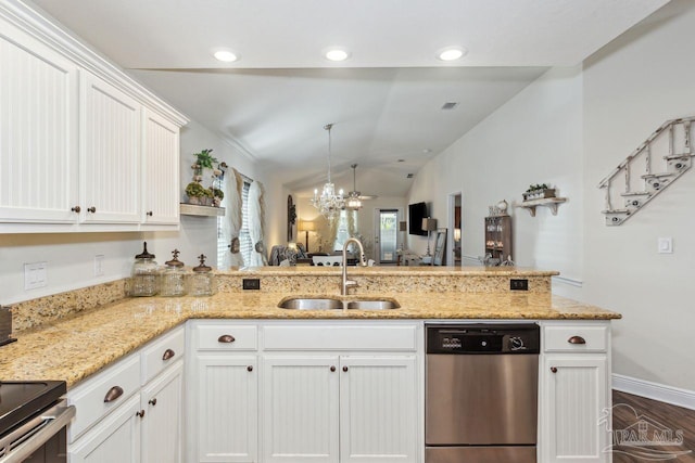 kitchen featuring appliances with stainless steel finishes, light stone counters, sink, white cabinetry, and lofted ceiling