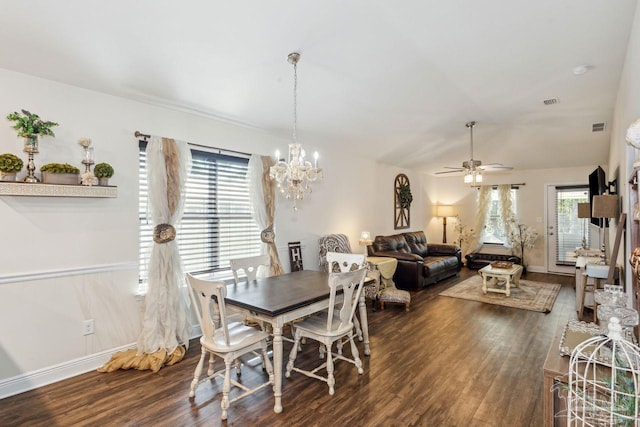 dining area featuring dark hardwood / wood-style floors and ceiling fan with notable chandelier