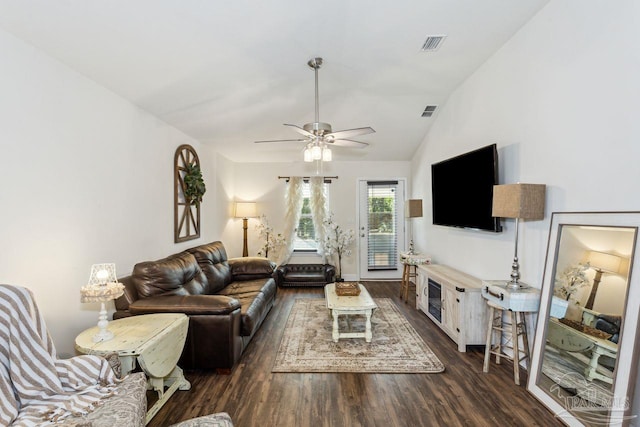 living room with ceiling fan, dark wood-type flooring, and vaulted ceiling