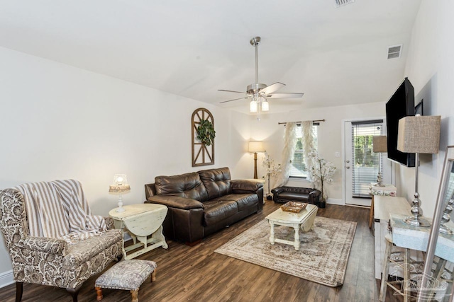 living room with ceiling fan and dark hardwood / wood-style flooring