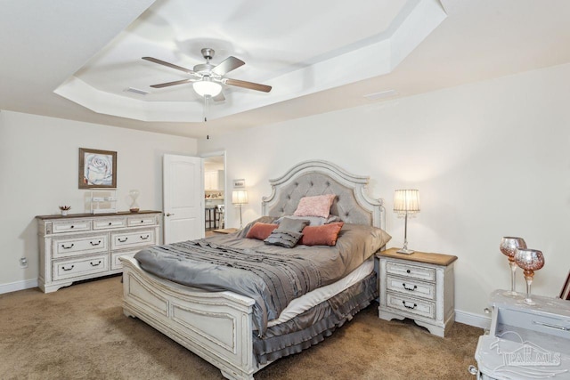 bedroom featuring a tray ceiling, ceiling fan, and light colored carpet