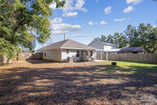 back of property with a lawn and cooling unit