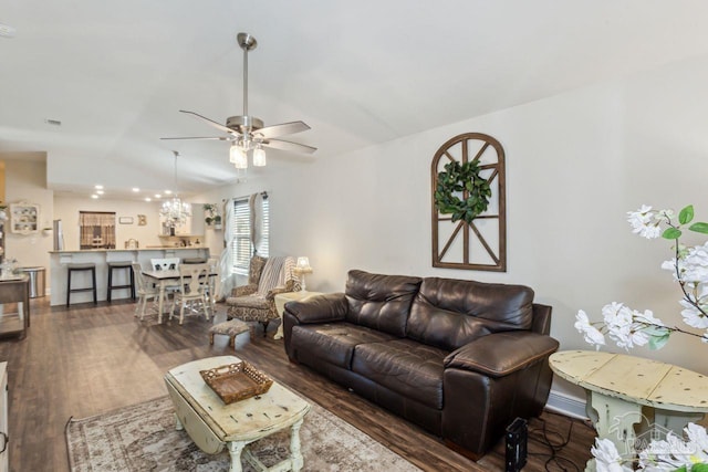 living room featuring ceiling fan, dark hardwood / wood-style floors, and lofted ceiling