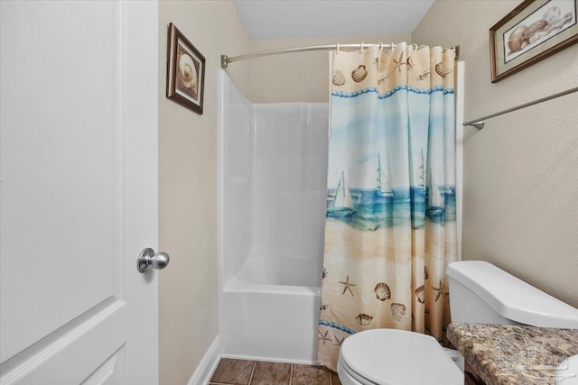 bathroom featuring shower / tub combo with curtain and toilet