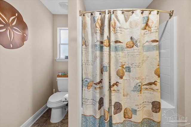 bathroom with tile patterned flooring, a shower with shower curtain, and toilet