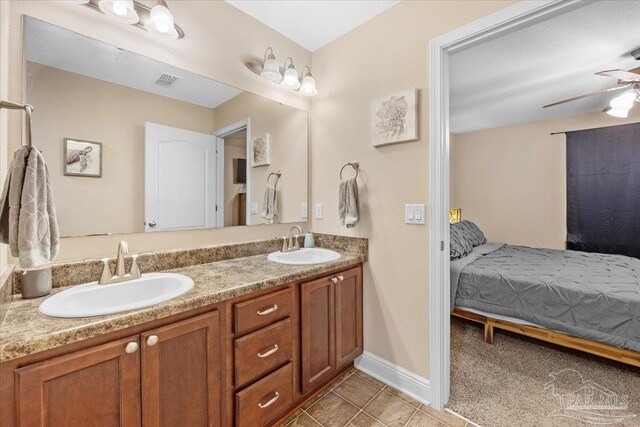 bathroom featuring tile patterned flooring, ceiling fan, and vanity