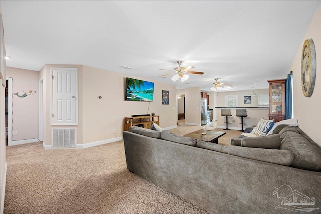 living room with carpet and ceiling fan