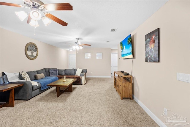 carpeted living room with ceiling fan