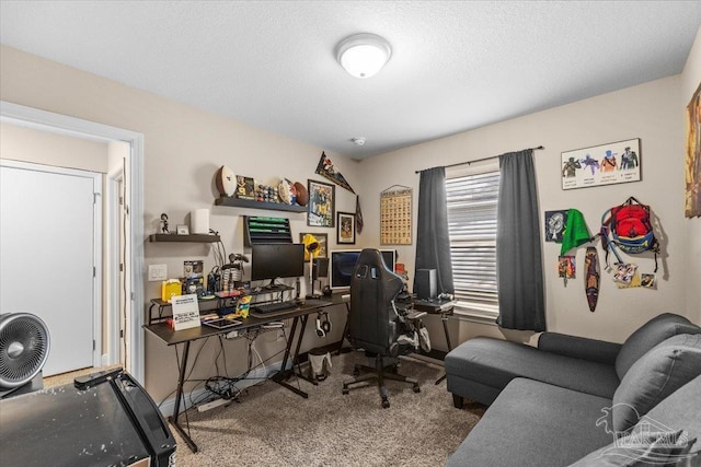 carpeted office featuring a textured ceiling