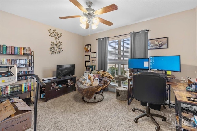 carpeted office space featuring ceiling fan