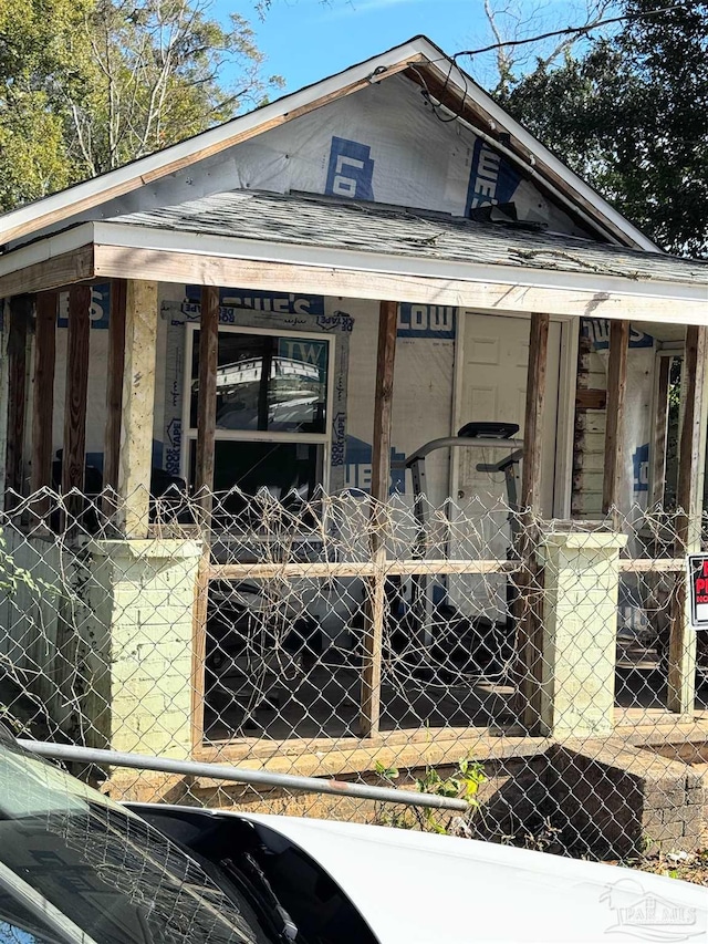 view of side of home featuring covered porch