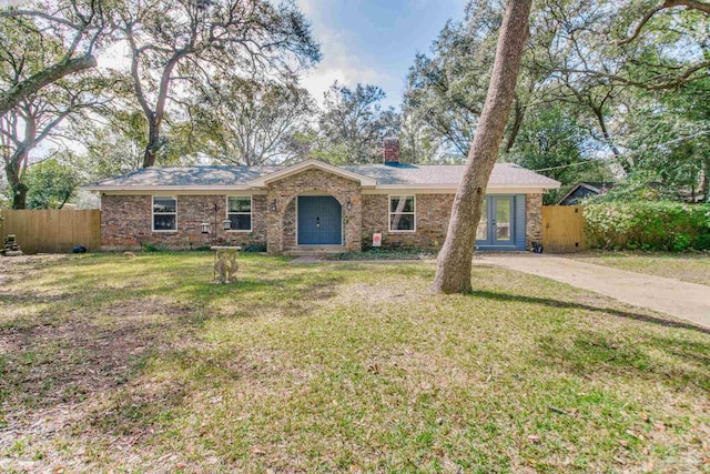 single story home with a front yard, concrete driveway, fence, and a chimney