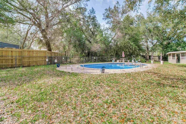 view of yard featuring a fenced in pool and fence