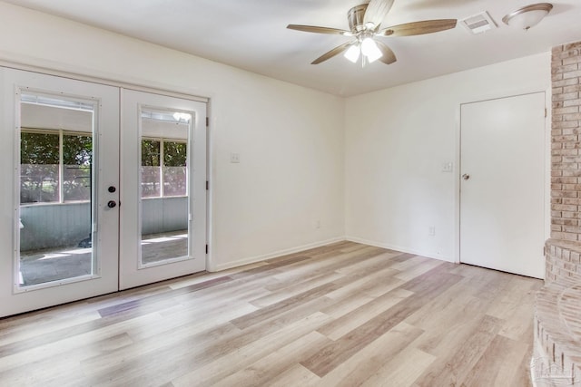 empty room with visible vents, baseboards, ceiling fan, light wood-type flooring, and french doors